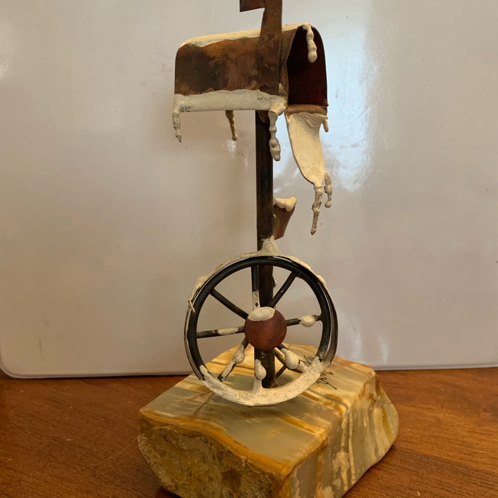 Rustic Metal Sculpture with Wheel on Stone Base